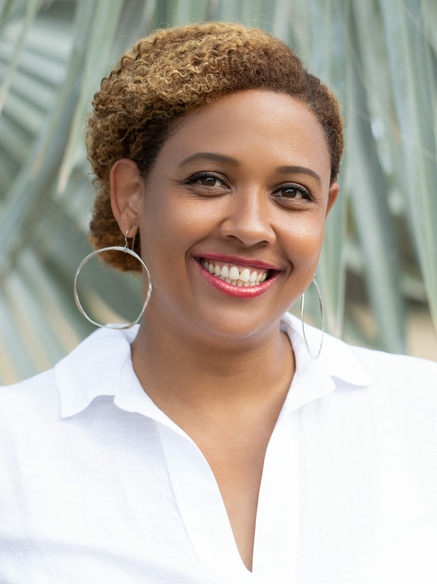 Headshot of Dr. Tami Navarro with a silver statue in the background